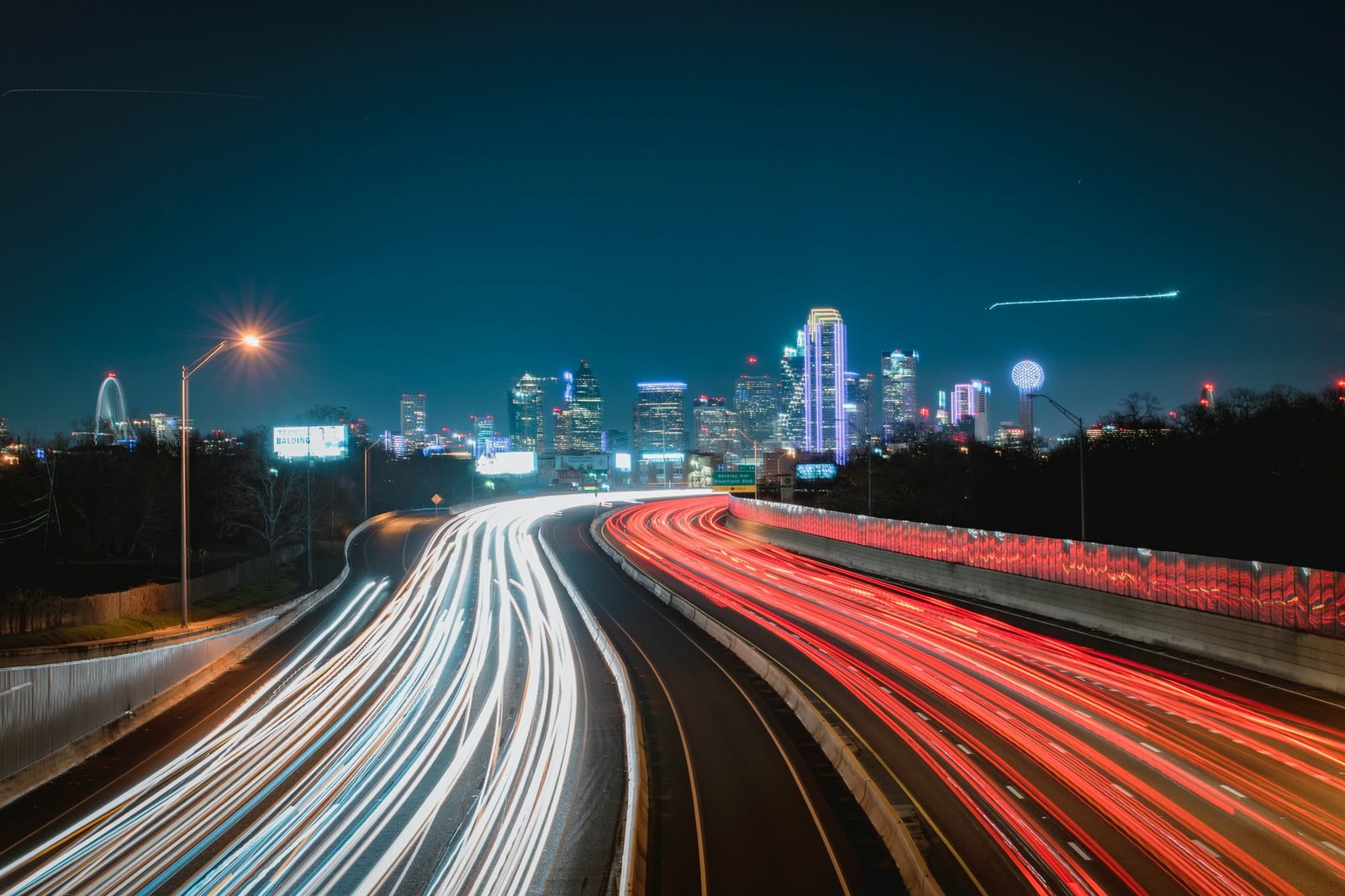 A highway curving into a city skyline at night